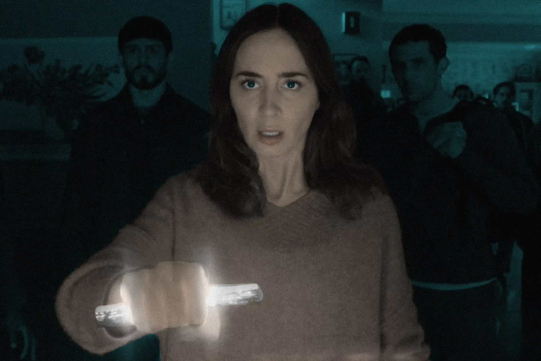 Emily Blunt holds a glowing alien artefact in her hand
